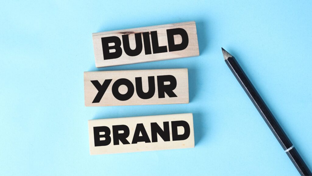 a message that says "build your brand" beside a pencil